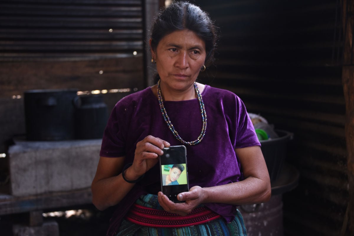 Rigoberta Vasquez, mother of sixteen-year-old migrant Carlos Hernandez Vasquez, who died Monday at a Border Patrol in Texas, shows a picture of her son on a mobile phone outside her house in San Jose El Rodeo village, Cubulco municipality, Baja Verapaz department, northwest of Guatemala City on May 22, 2019.