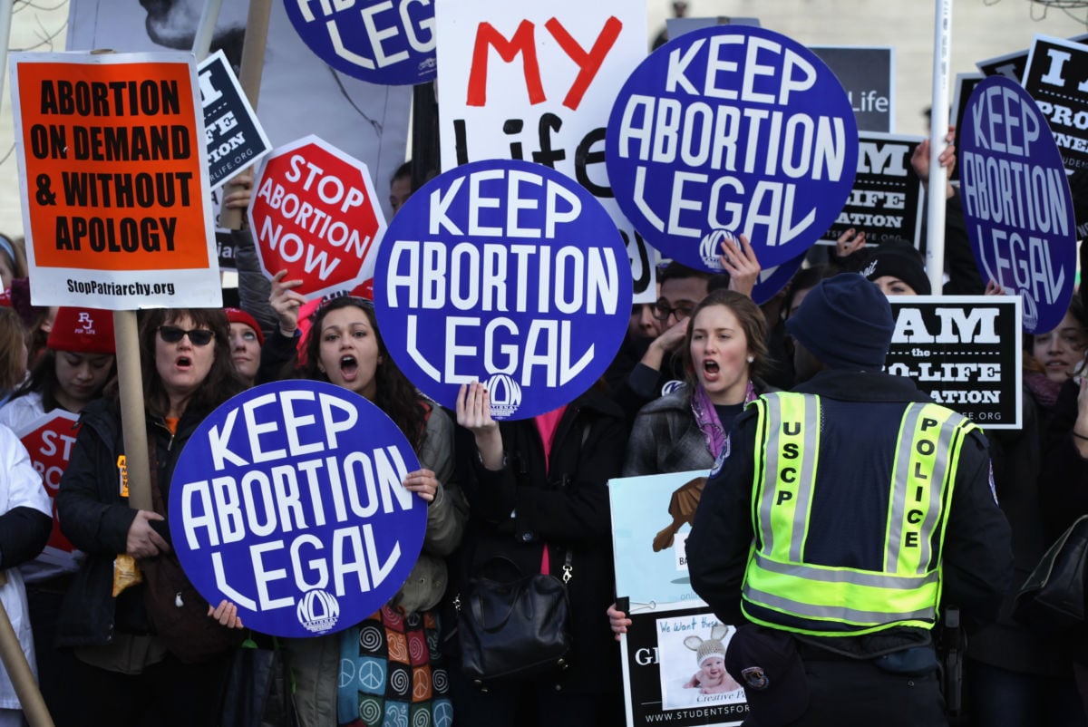 Pro-choice activists shout slogans before the annual March for Life passes by the U.S. Supreme Court January 22, 2015, in Washington, D.C. Anti-choice activists gathered in the nation's capital to mark the 1973 Supreme Court decision that legalized abortion.