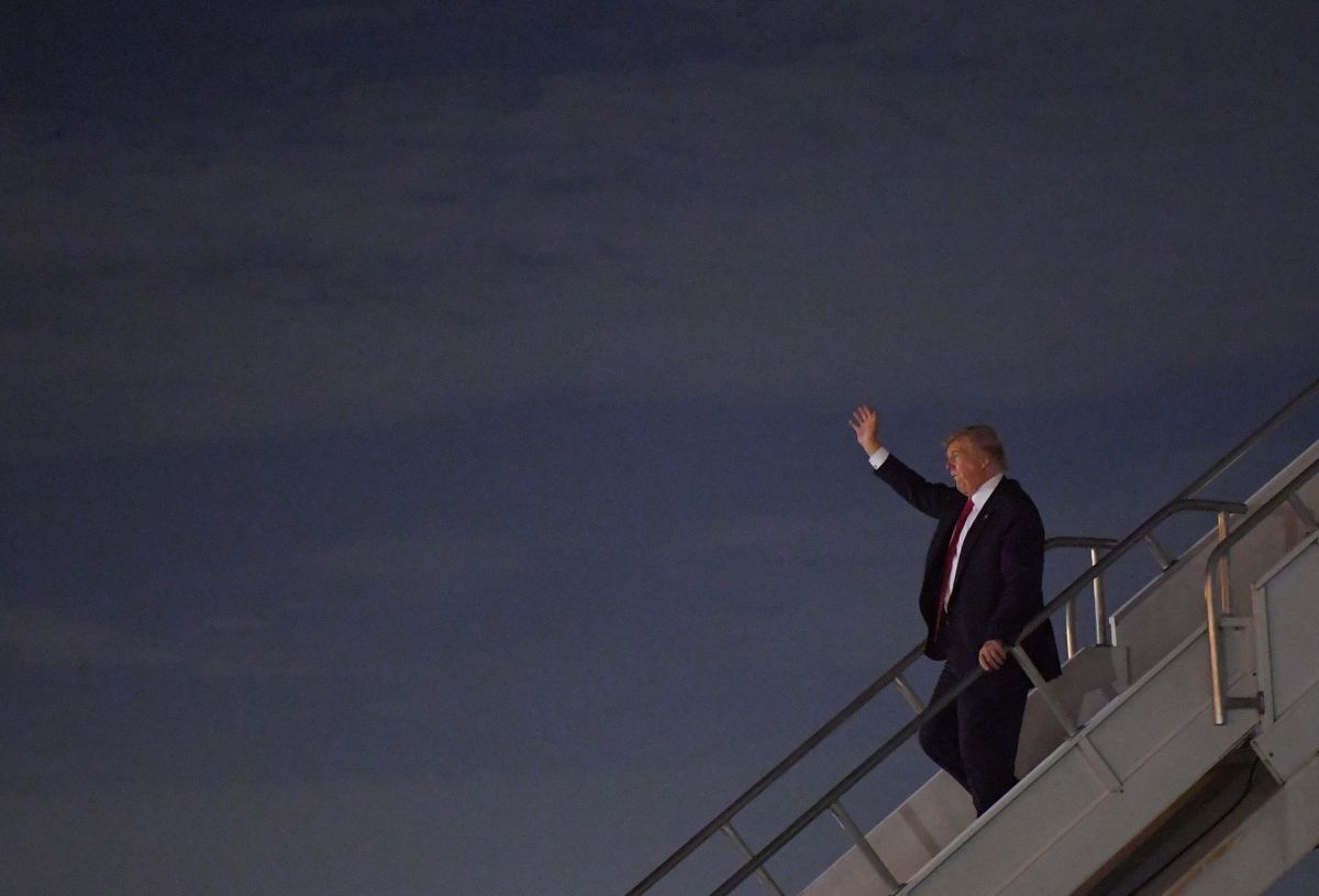 Donald Trump exits an airplane