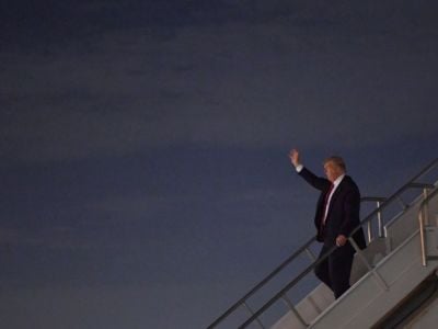Donald Trump exits an airplane