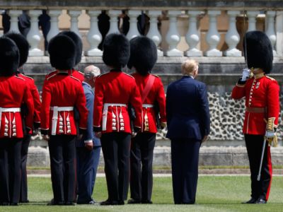 Donald Trump stands near British soldiers
