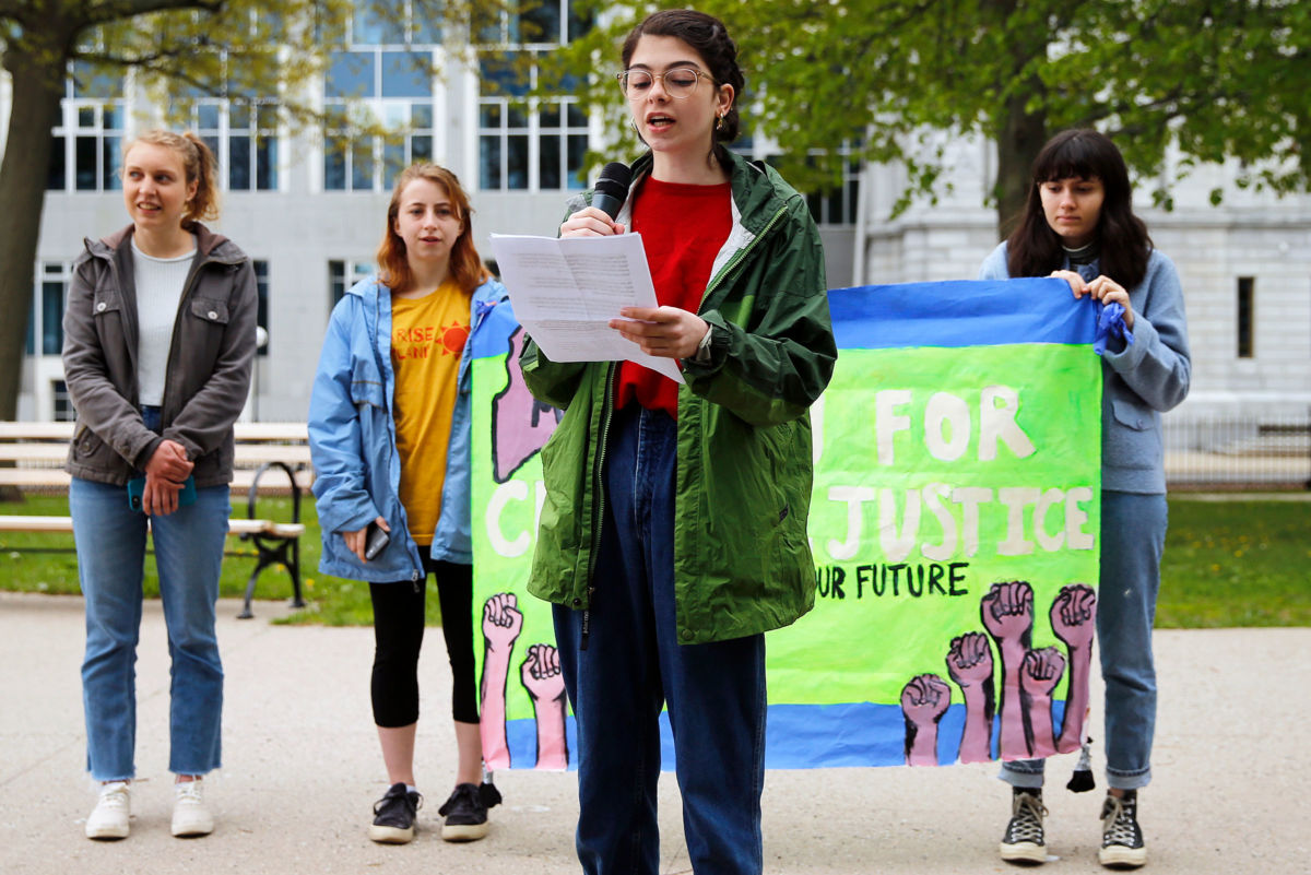 Ruby Peterman, 16, a student at Baxter Academy for Technology and Science, speaks in Lincoln Park on Saturday as part of a series of coordinated national and international press conferences by youth climate activists in the run up to an appellate court hearing in the landmark constitutional youth climate lawsuit, Juliana v. United States.