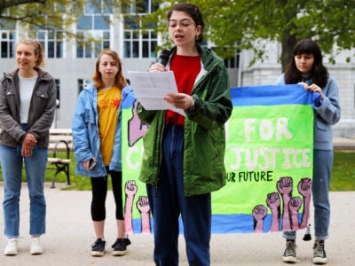 Ruby Peterman, 16, a student at Baxter Academy for Technology and Science, speaks in Lincoln Park on Saturday as part of a series of coordinated national and international press conferences by youth climate activists in the run up to an appellate court hearing in the landmark constitutional youth climate lawsuit, Juliana v. United States.