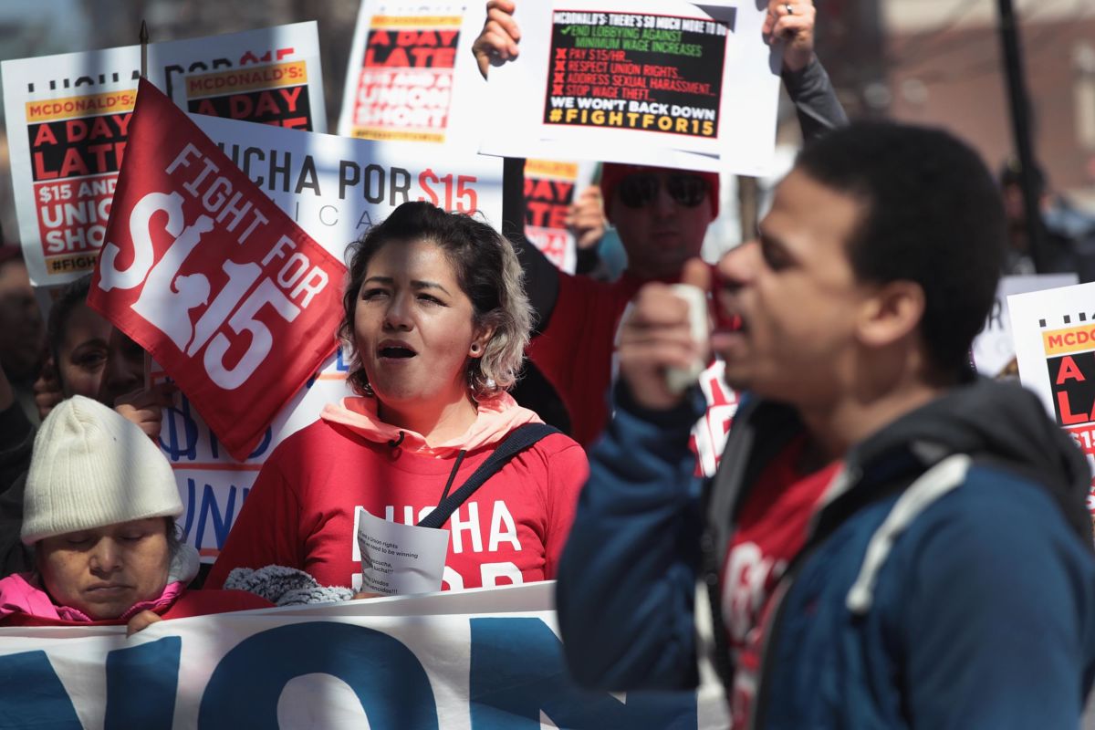 People wearing red march and chat while holding pro-union signs