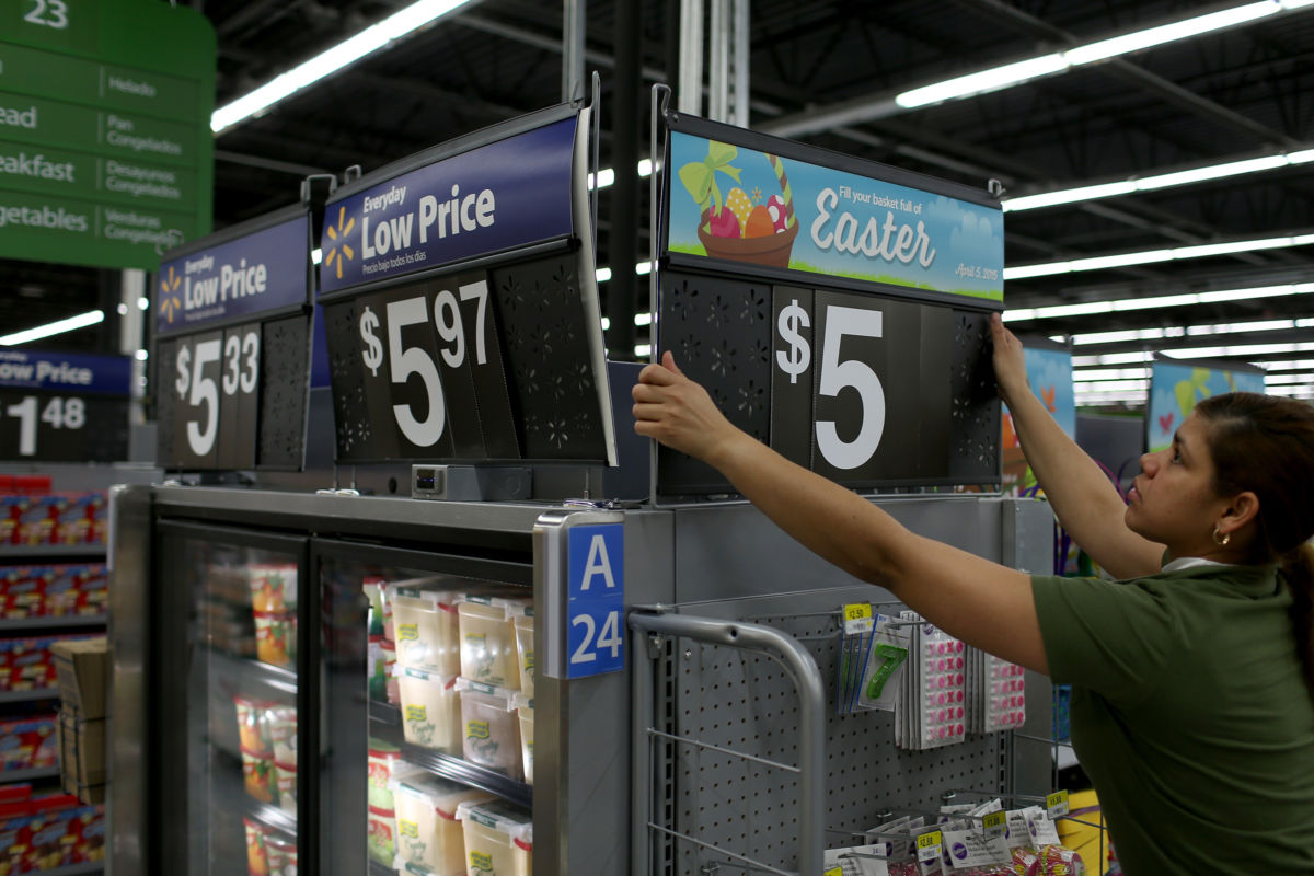 Walmart employee Yanetsi Grave works in a Walmart store on February 19, 2015 in Miami, Florida. Average Walmart workers make twice the federal minimum wage but may still qualify for public benefits.