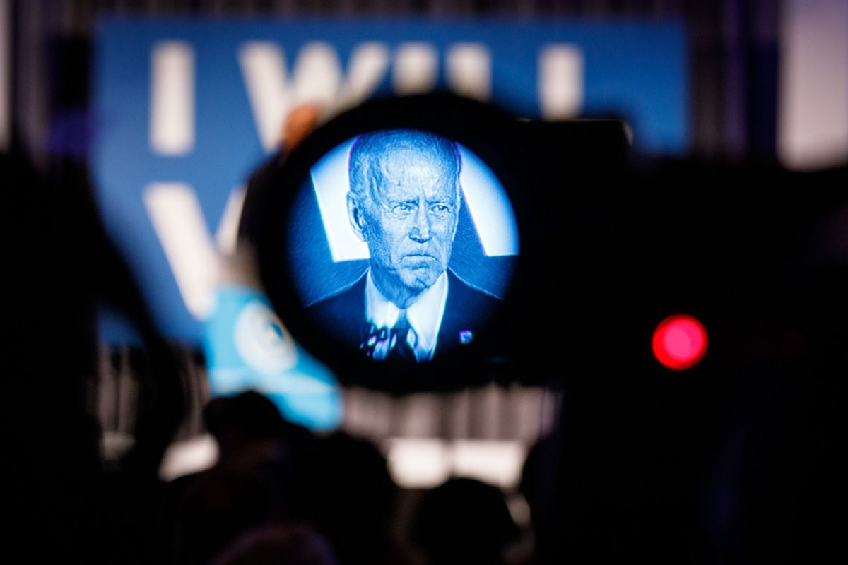 Joe Biden is seen through the viewfinder of a camera