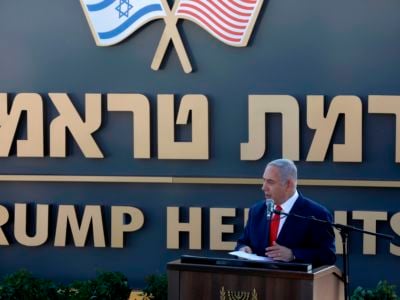 Benjamin Netanyahu stands in front of a sign reading "TRUMP HEIGHTS"