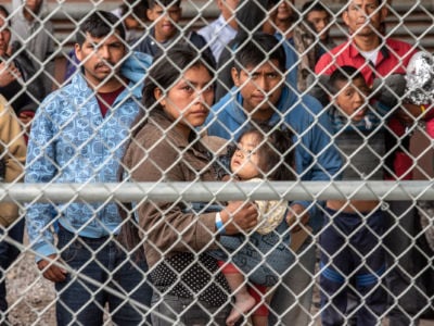 Migrants are gathered inside the fence of a makeshift detention center in El Paso, Texas, on March 27, 2019.