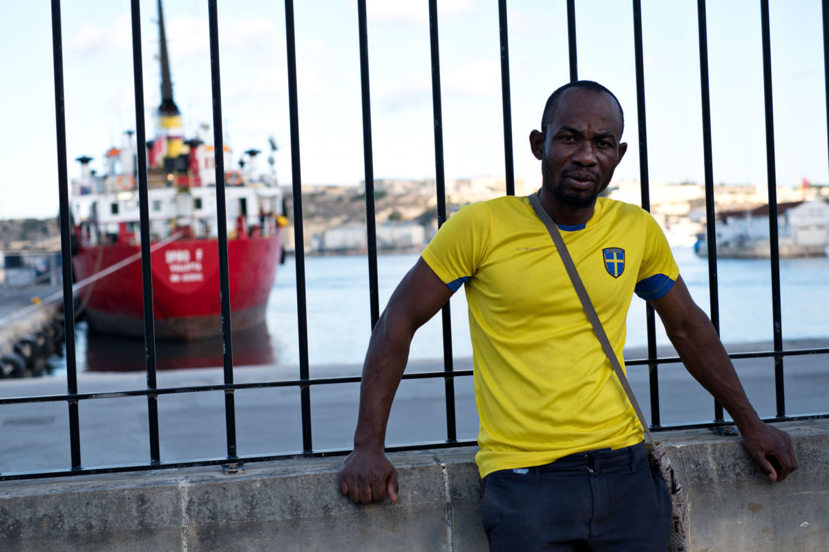 Emmanuel Freedom outside an open center for refugees in Marsa, Malta.