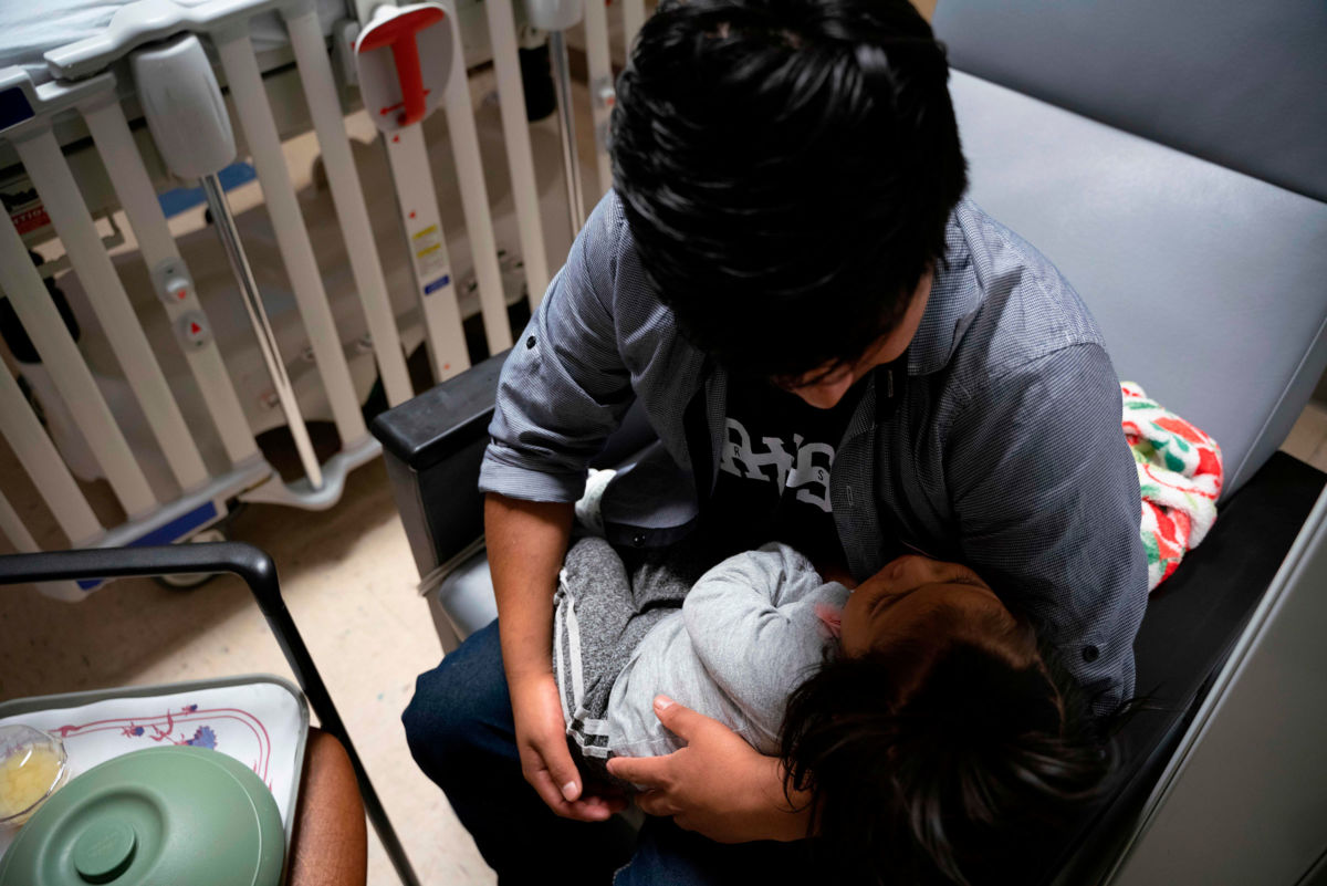 Guatemalan Luis Miguel takes care of his daughter Marisol at a pediatric intensive care unit