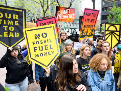 Protesters seen with placards during a Sunrise NYC rally in support of the Green New Deal outside Sen. Chuck Schumer's office on Third Avenue in New York City, April 30, 2019.