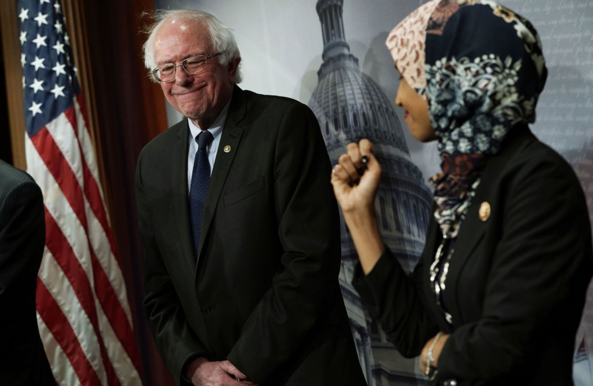 Rep. Ilhan Omar and Sen. Bernie Sanders share a moment during a news conference, January 10, 2019, at the Capitol in Washington, D.C.