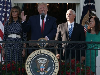 Donald and Melania Trump, Mike Pence and Karen Pence stand on a balcony