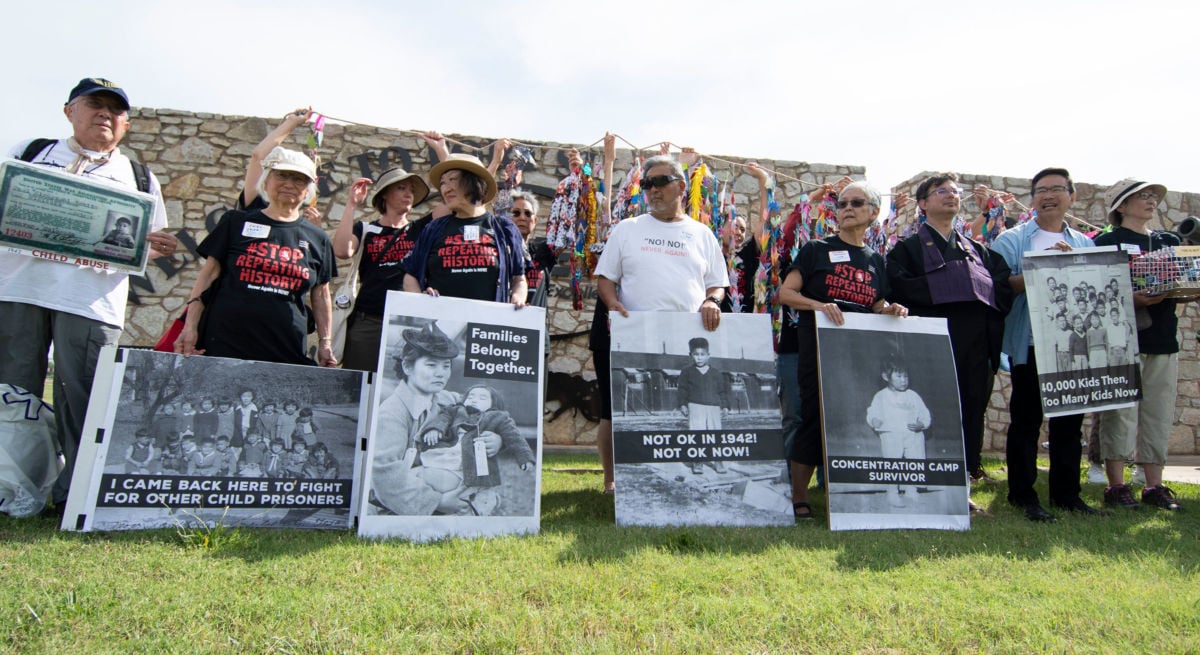 A group of Japanese Americans who were held in concentration camps in WWII pose with photos of themselves during a press conference on June 22, 2019, in Lawton, Oklahoma, to protest the military base, Fort Sill, being used to house 1,400 migrant children.