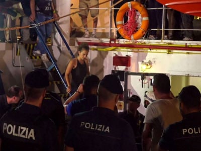 An image grab taken from a video released by Local Team on June 29, 2019, shows the Sea-Watch 3 charity ship's German captain Carola Rackete being arrested by Italian police, in the Italian port of Lampedusa, Sicily.