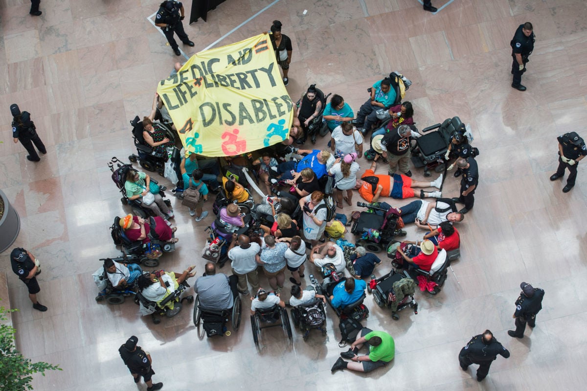 Demonstrators gather in the atrium of Hart Building to protest the Senate's health care bill on July 25, 2017.