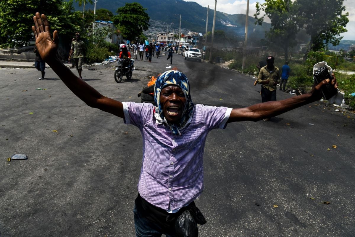 A demonstrator shouts slogans during a protest march against the ruling government in Port-au-Prince on June 13, 2019.