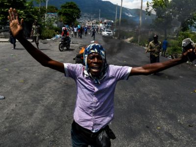 A demonstrator shouts slogans during a protest march against the ruling government in Port-au-Prince on June 13, 2019.