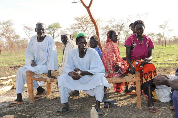 People sit on a bench.