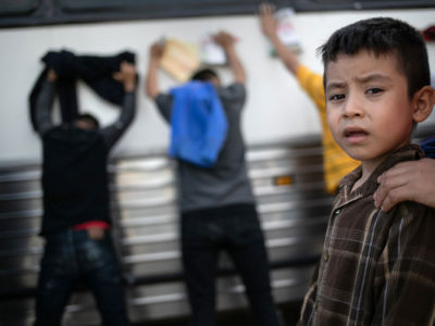 Immigrants wait to be searched and then bussed to U.S. Border Patrol facility in McAllen after crossing the border from Mexico on July 2, 2019, in Los Ebanos, Texas.