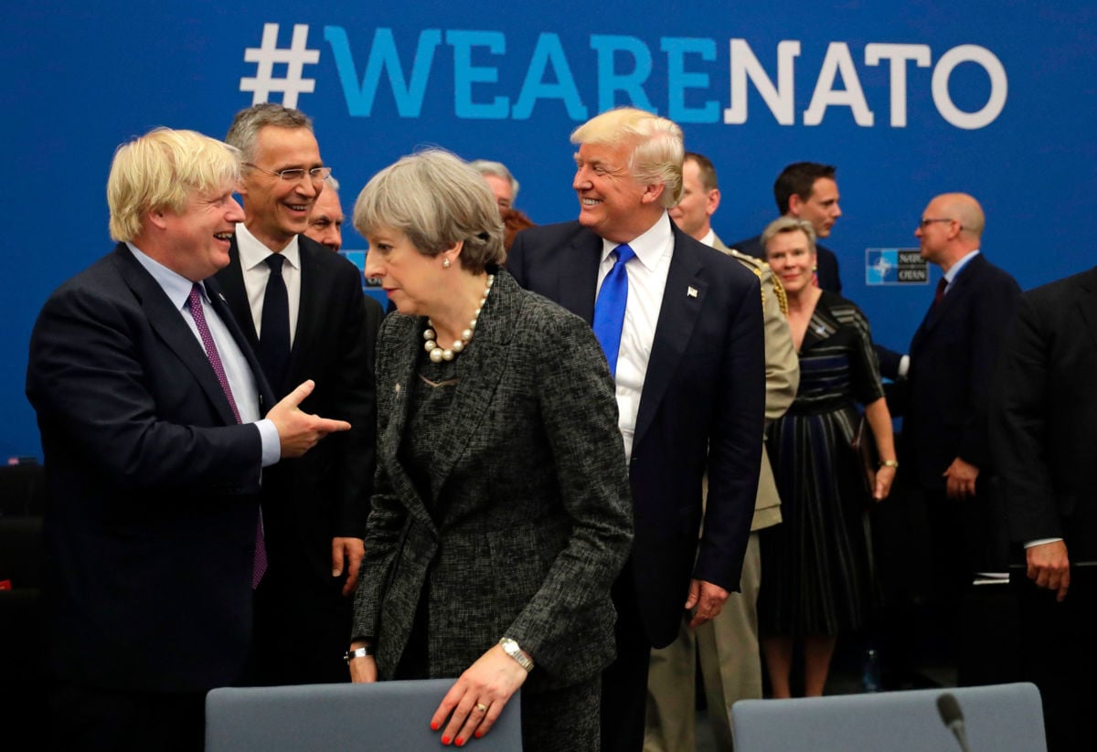 President Trump speaks to NATO Secretary General Jens Stoltenberg and British Foreign Minister Boris Johnson as Britain's Prime Minister Theresa May passes during a working dinner meeting at the NATO headquarters in Brussels on May 25, 2017.
