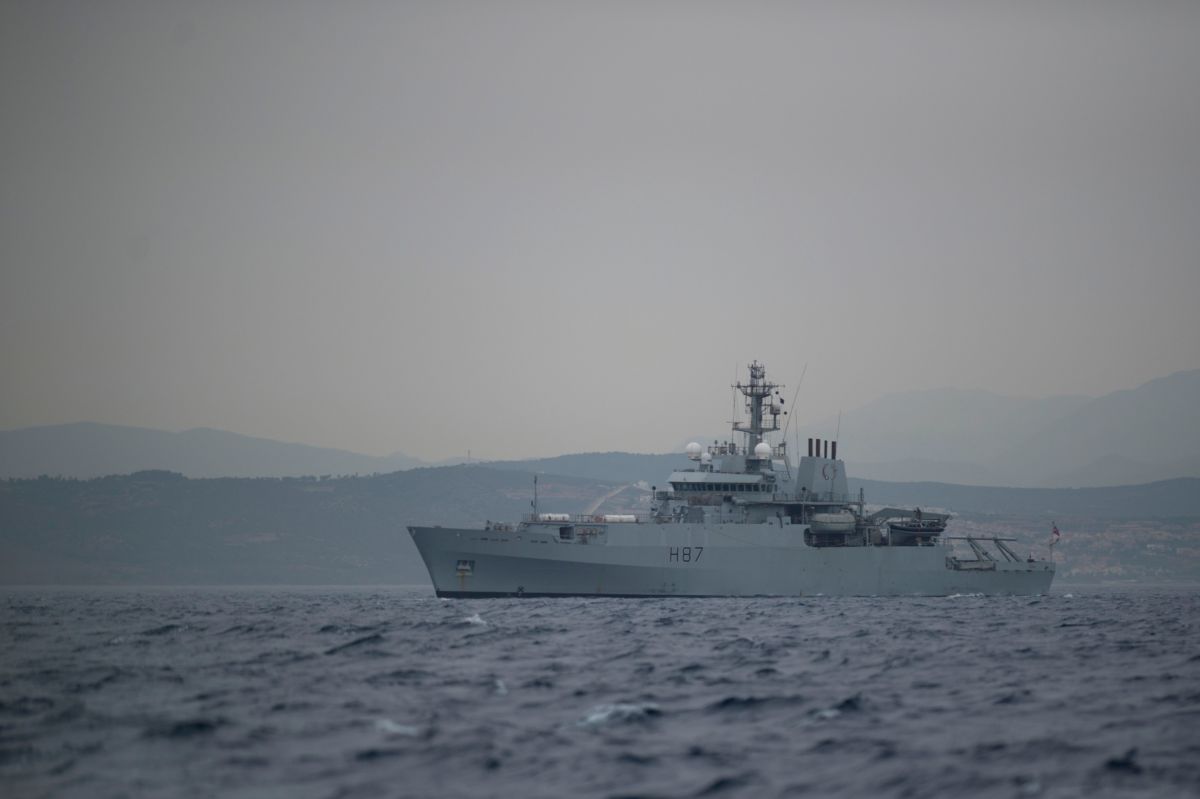 A naval vessel is seen in a large body of water