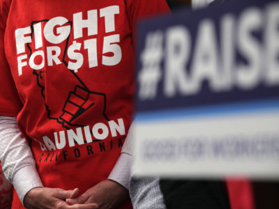 An activist wears a "Fight For $15" T-shirt during a news conference prior to a vote on the Raise the Wage Act July 18, 2019, at the U.S. Capitol in Washington, D.C.
