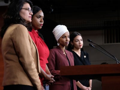 Reps. Rashida Tlaib, Ayanna Pressley, Ilhan Omar and Alexandria Ocasio-Cortez pause between answering questions during a press conference at the U.S. Capitol on July 15, 2019, in Washington, D.C.