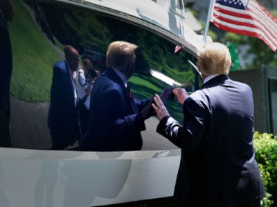 President Trump knocks on the hull of a power boat as he tours his 'Made In America' product showcase at the White House, July 15, 2019, in Washington, D.C.