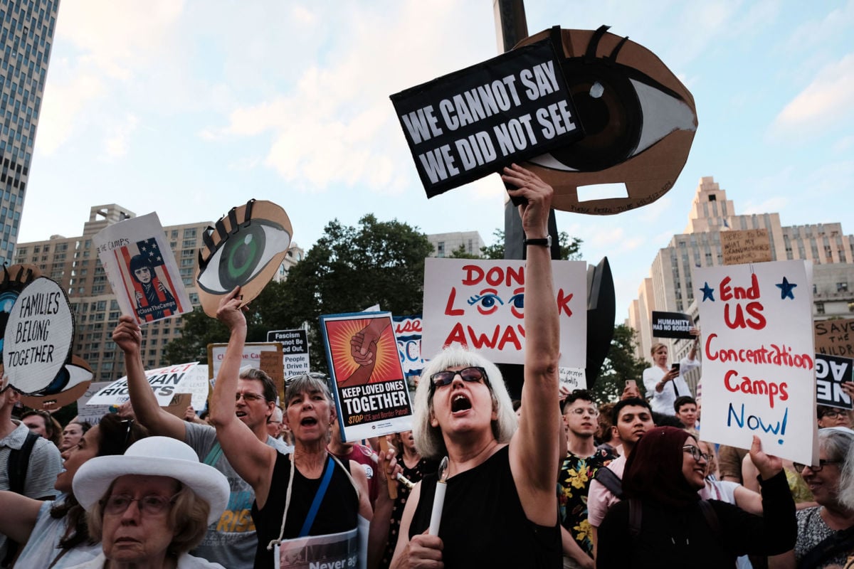 Hundreds of people gather in lower Manhattan for a "Lights for Liberty" protest against migrant detention camps and the impending raids by Immigration and Customs Enforcement on July 12, 2019, in New York City.