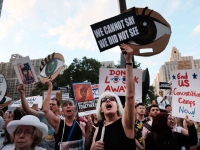 Hundreds of people gather in lower Manhattan for a "Lights for Liberty" protest against migrant detention camps and the impending raids by Immigration and Customs Enforcement on July 12, 2019, in New York City.