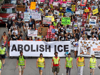 Protesters march to offices of the U.S. Immigration and Customs Enforcement on July 13, 2019, in Chicago, Illinois.