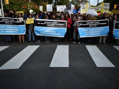 Protesters block the street displaying signs demanding that Donald Trump denounce white nationalism