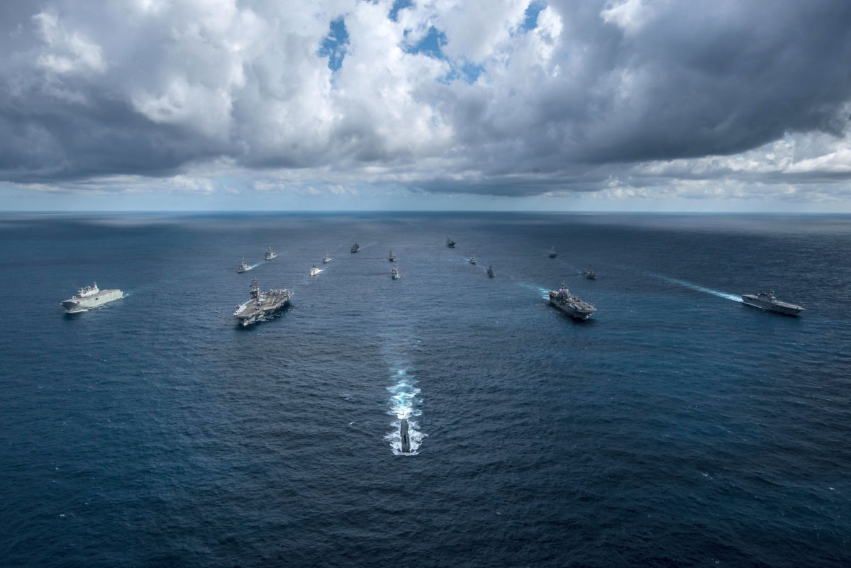 Naval ships sail in formation