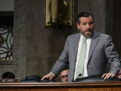 Sen. Ted Cruz stands up from a chair