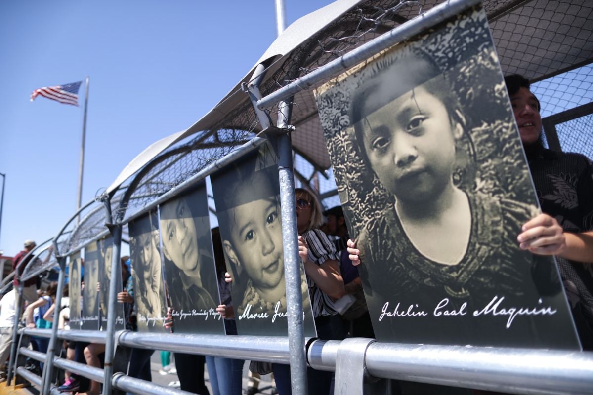 Activists hold photos of migrant children who died trying to cross the U.S.-Mexico border, as they demonstrate standing on the Paso Del Norte Port of Entry bridge, on June 27, 2019, in Ciudad Juarez, Mexico.