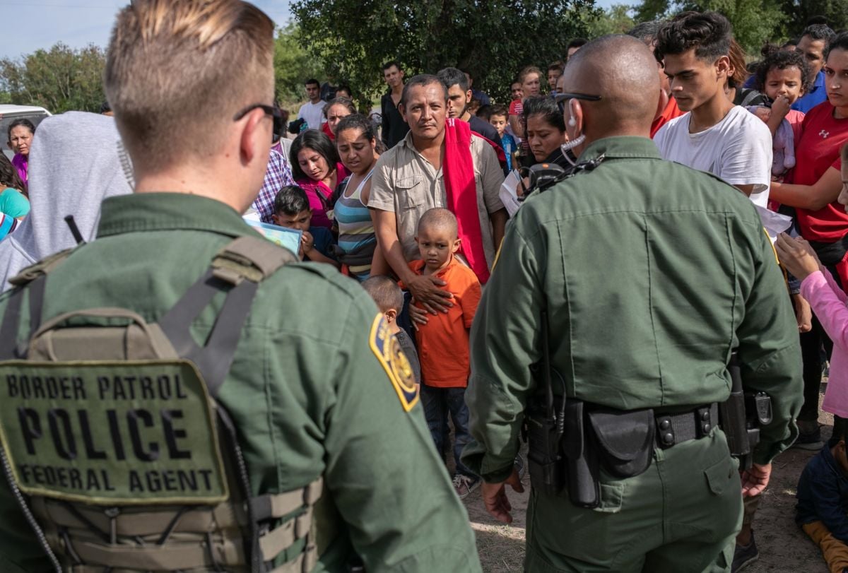 U.S. Border Patrol agents watch over immigrants after taking them into custody on July 02, 2019 in Los Ebanos, Texas. Hundreds of immigrants, most from Central America, turned themselves in to border agents after rafting across the Rio Grande from Mexico to seek political asylum in the United States.