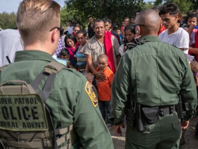 U.S. Border Patrol agents watch over immigrants after taking them into custody on July 02, 2019 in Los Ebanos, Texas. Hundreds of immigrants, most from Central America, turned themselves in to border agents after rafting across the Rio Grande from Mexico to seek political asylum in the United States.