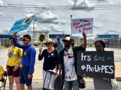 A small group holds signs during a protest march