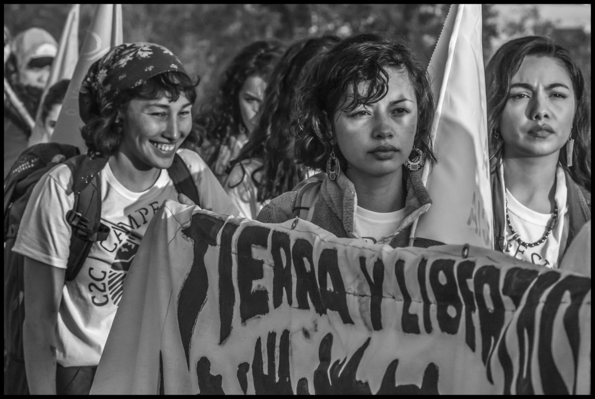 Young women carry the banner of the new cooperative set up by Community to Community, Tierra y Libertad.