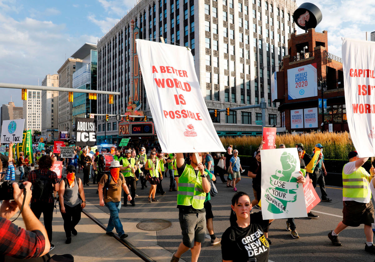 Protesters march down Woodward Ave. in front of the Fox Theatre on July 30, 2019, in Detroit, Michigan.