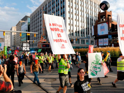 Protesters march down Woodward Ave. in front of the Fox Theatre on July 30, 2019, in Detroit, Michigan.