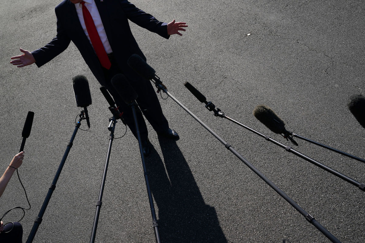 President Trump talks to journalists before departing the White House, July 30, 2019, in Washington, D.C.