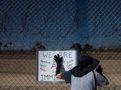Jeanne Egasse, 67, of Tustin, holds a sign up outside the James A. Musick Facility, a detention center that houses unauthorized immigrants, in Irvine, California, on June 30, 2018.