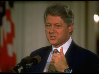 Bill Clinton speaks into a microphone