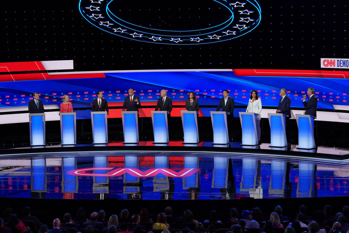 Democratic candidates for the presidency stand behind their respective podiums on the debate stage