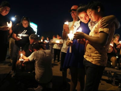 People attend a candlelight prayer vigil outside Immanuel Baptist Church, located near the scene of a mass shooting which left at least 22 people dead, on August 5, 2019, in El Paso, Texas.