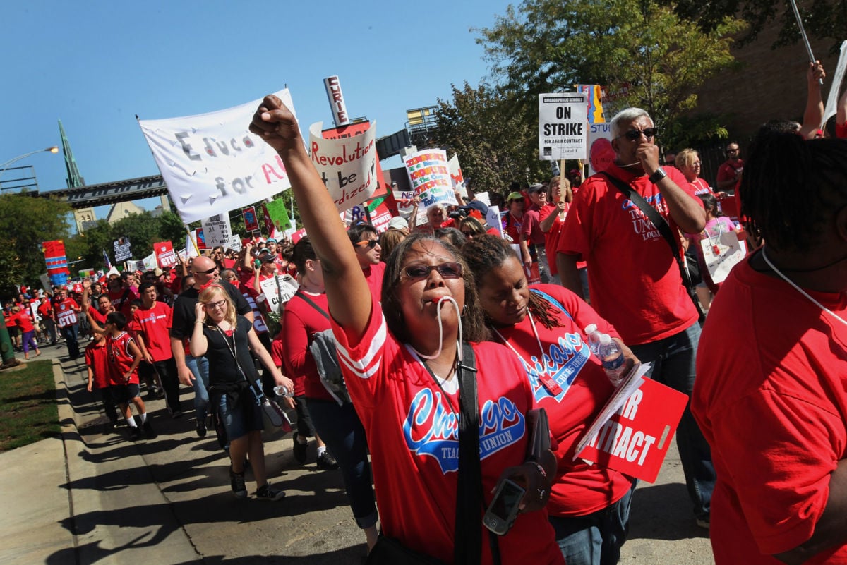 Striking Chicago public school teachers and their supporters march through the streets on September 15, 2012, in Chicago, Illinois.