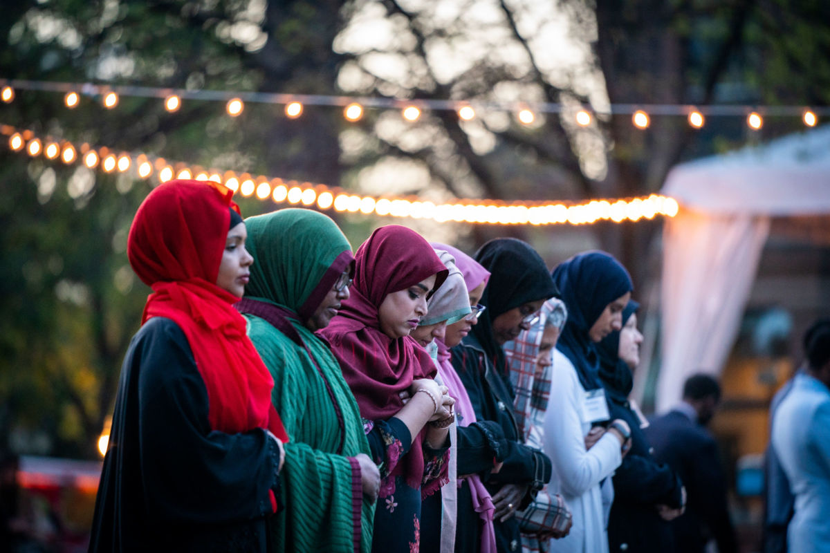 nine Muslim women in colorful hijabs stand in a line, islamophobia, islam