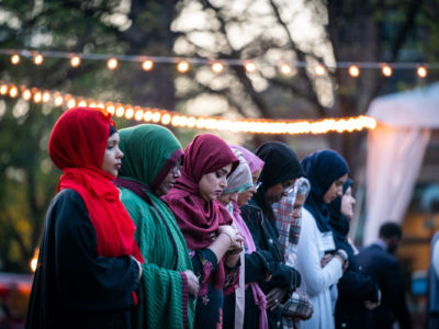 nine Muslim women in colorful hijabs stand in a line, islamophobia, islam